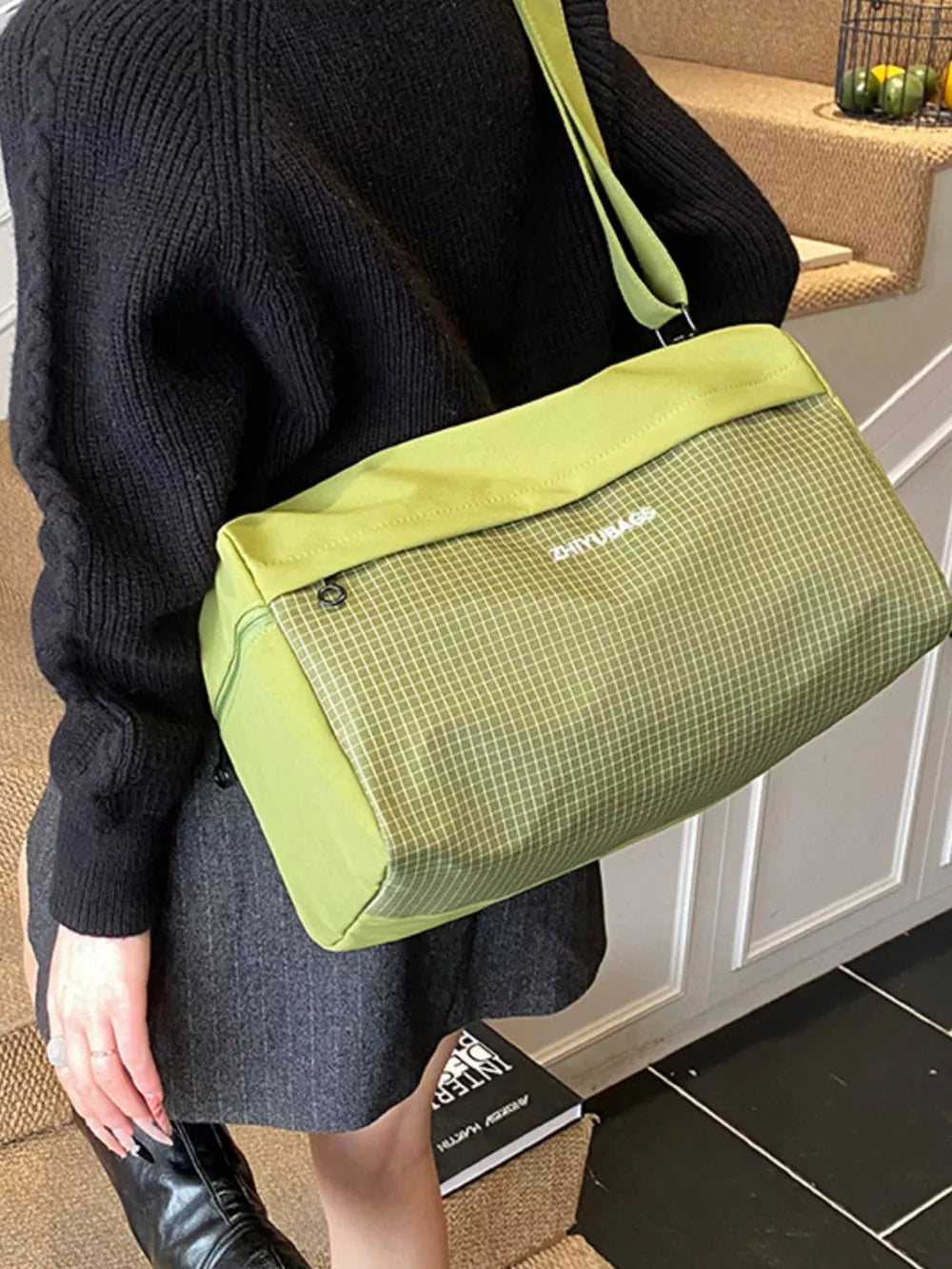 Green plaid Oxford travel bag with zipper detail and adjustable strap.