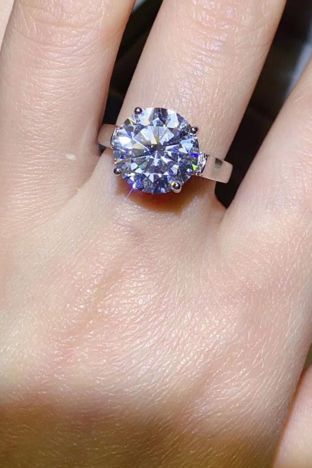 Silver ring with large radiant moissanite solitaire and pavé shoulders