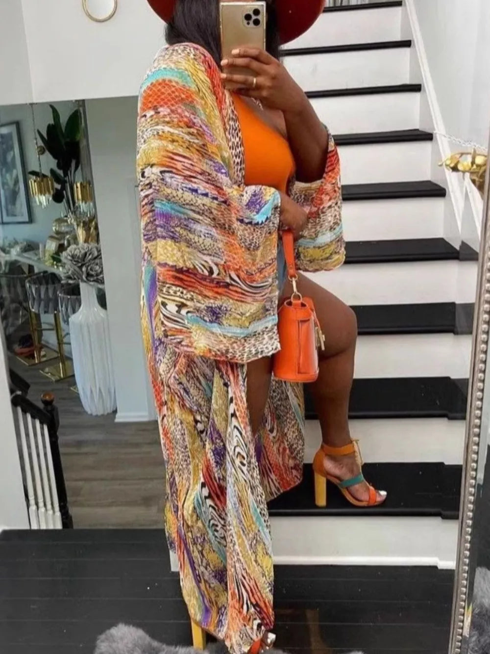 Vibrant bohemian print open-front cardigan with wide sleeves and abstract patterns.