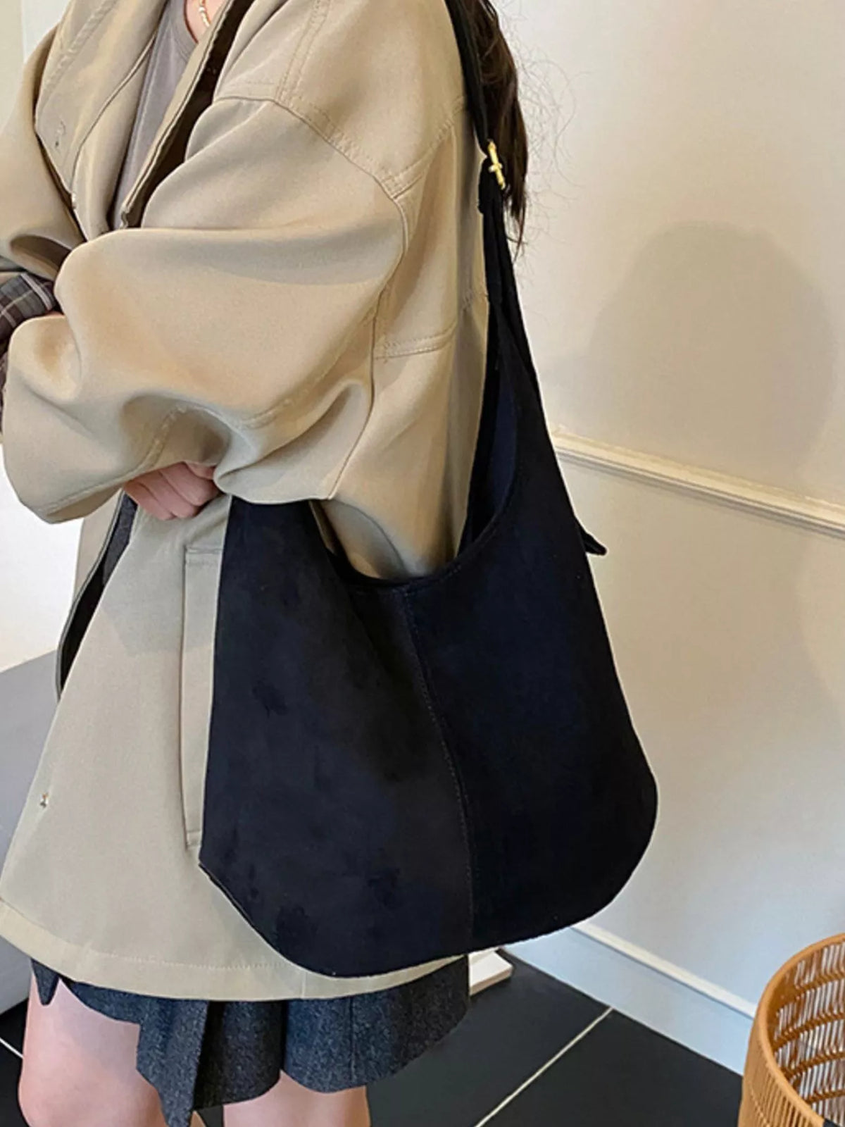 Large black suede hobo shoulder bag with a slouchy silhouette and gold hardware detail.