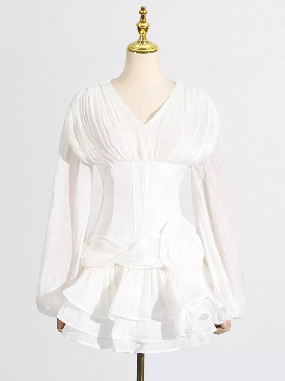 White ruffle mini dress with balloon sleeves and a ruched bodice.