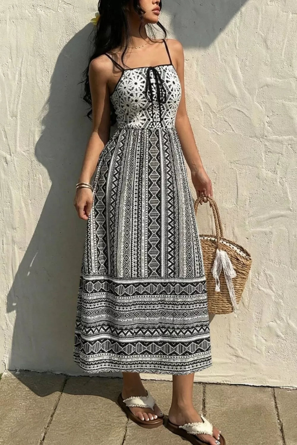 Black and white geometric print cami dress with tie-front bodice and maxi skirt.