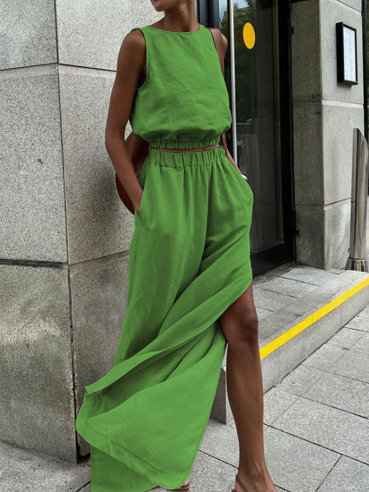Green sleeveless crop top and wide-leg pants set with crew neck and elastic waist.