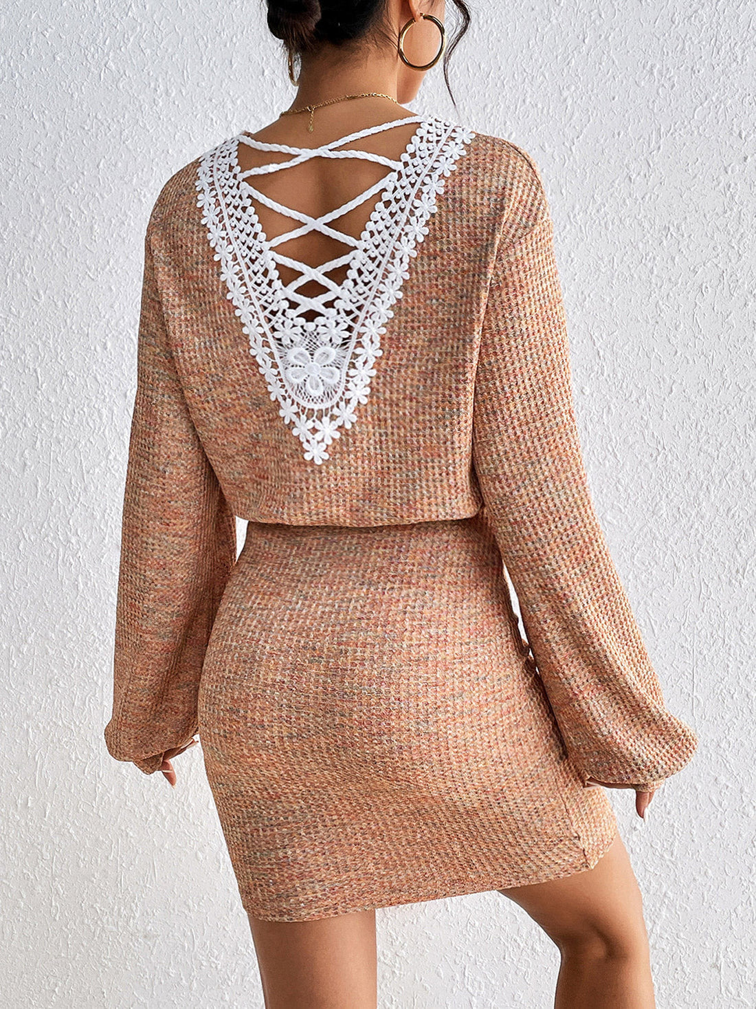 Tan knit mini dress set with lace-up back detail and long sleeves.