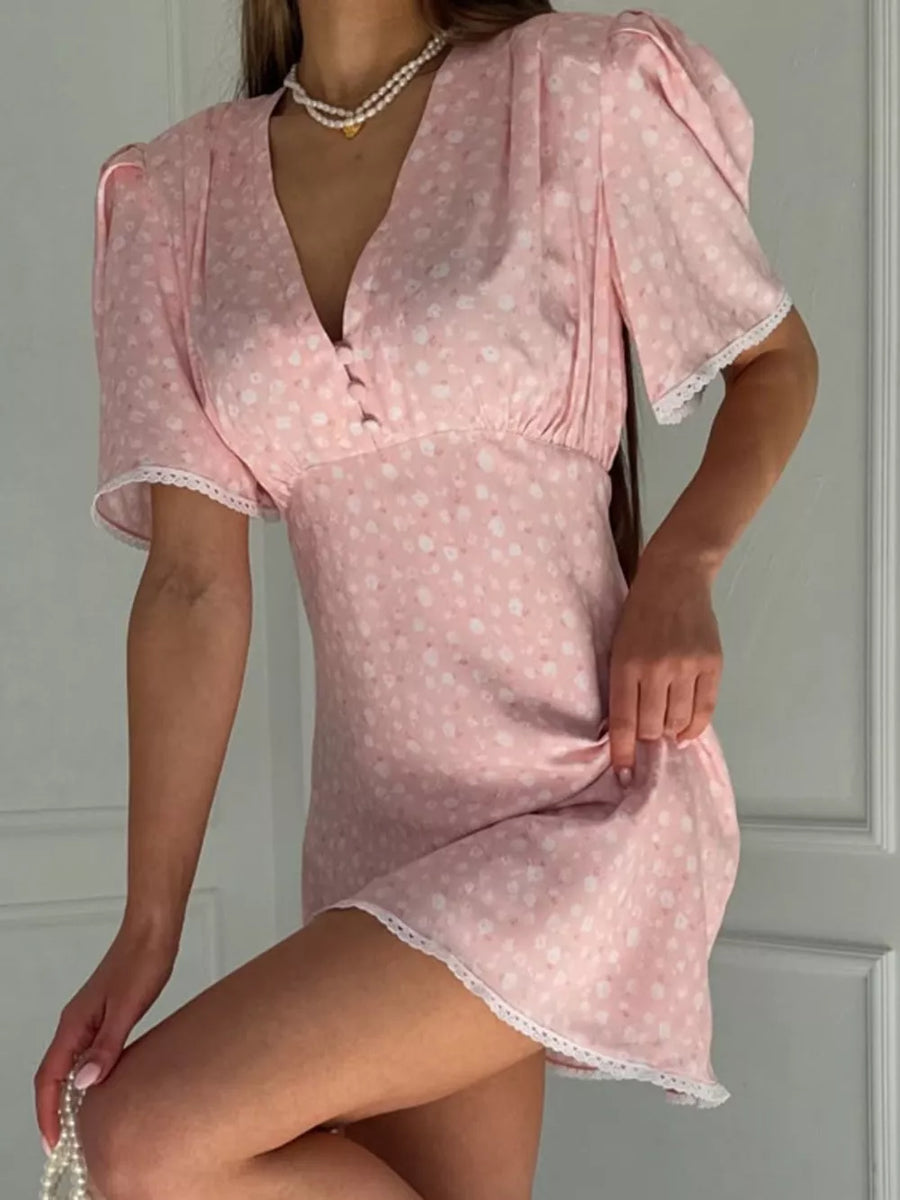 Pink floral print mini dress with puff sleeves, V-neck, and lace trim.