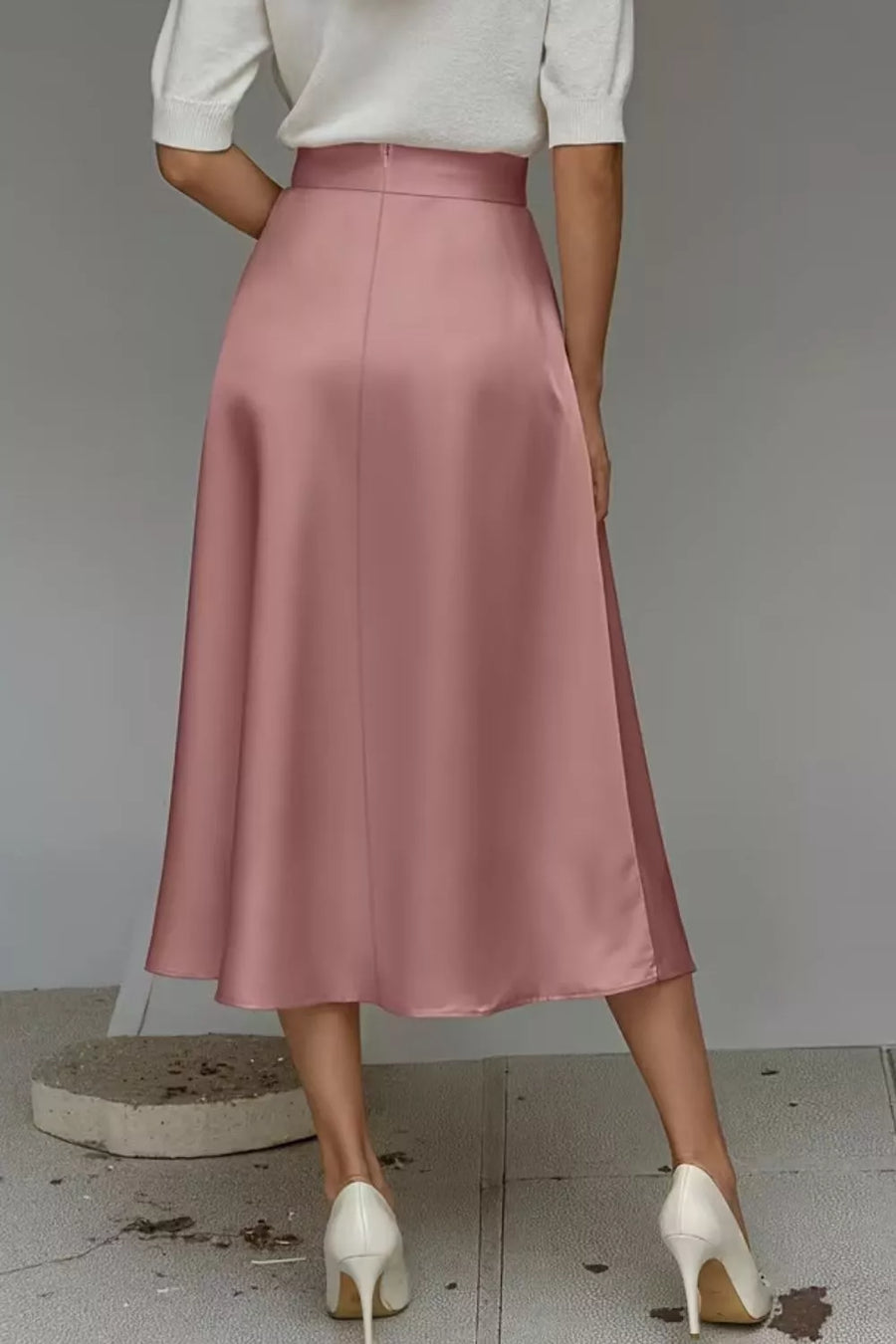 Dusty Pink a-line midi skirt with hidden pockets, made of lustrous fabric.