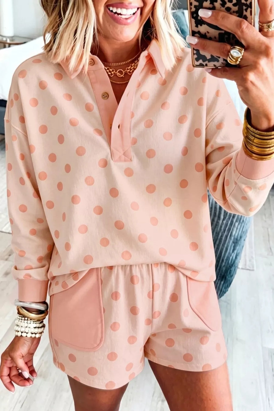 Pink polka dot lounge set with collared long sleeve top and shorts with pockets.