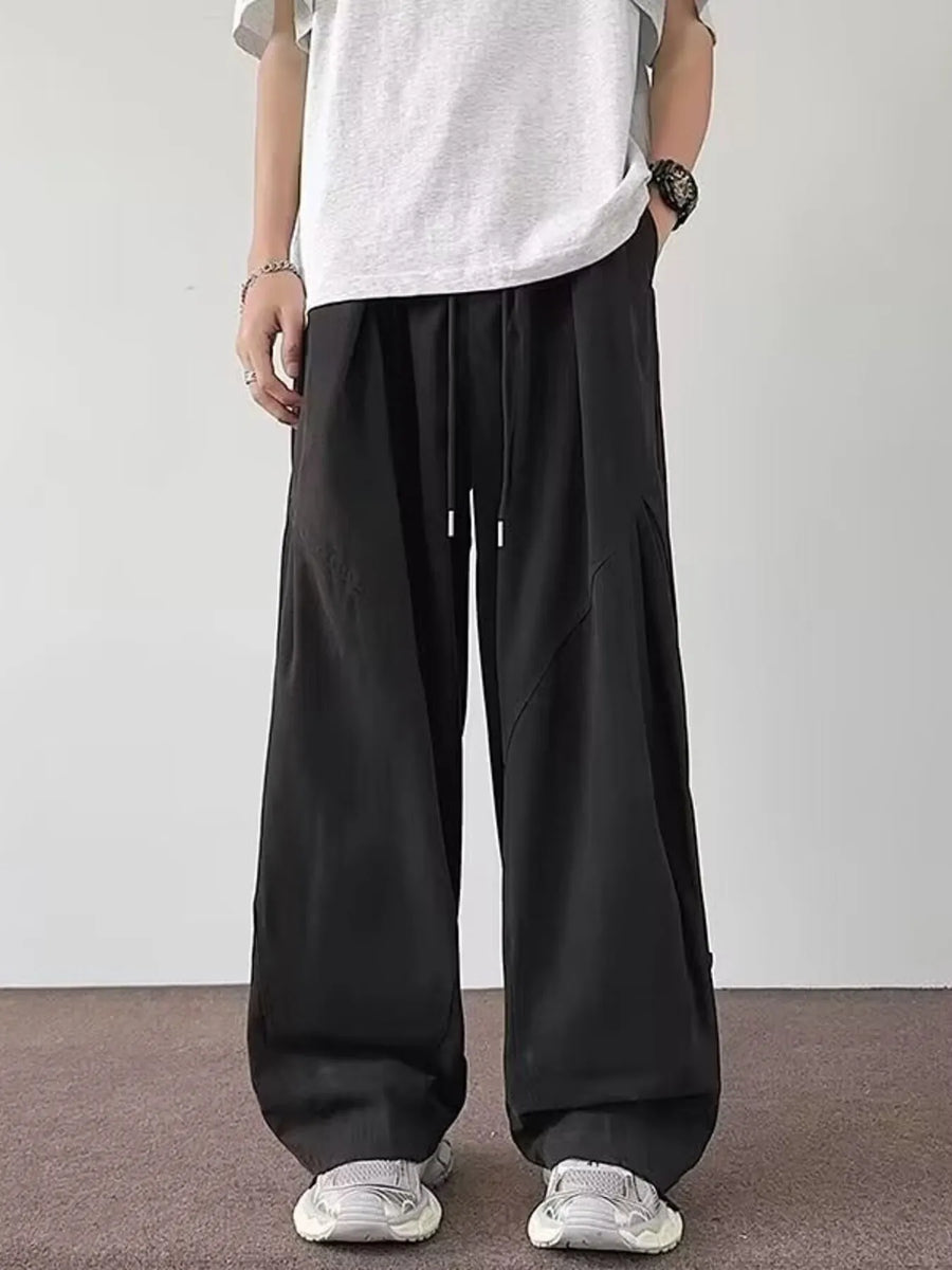 Black relaxed fit casual cargo pants with drawstring waist and wide leg.