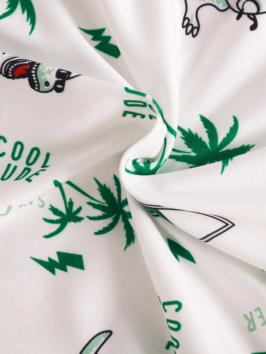 Baby polo and shorts set fabric with white background, green dinosaur, palm tree, and text print.