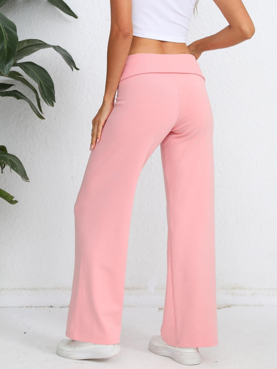 Blush pink palazzo trousers with a fold-over waistband and wide leg.