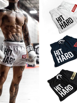 Hit Hard mesh training shorts in black, navy, and white with drawstring waist and bold lettering.