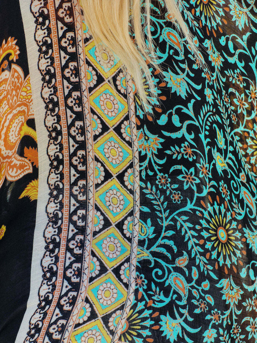 Bohemian patchwork print kimono in black with turquoise and orange floral patterns and diamond accents.
