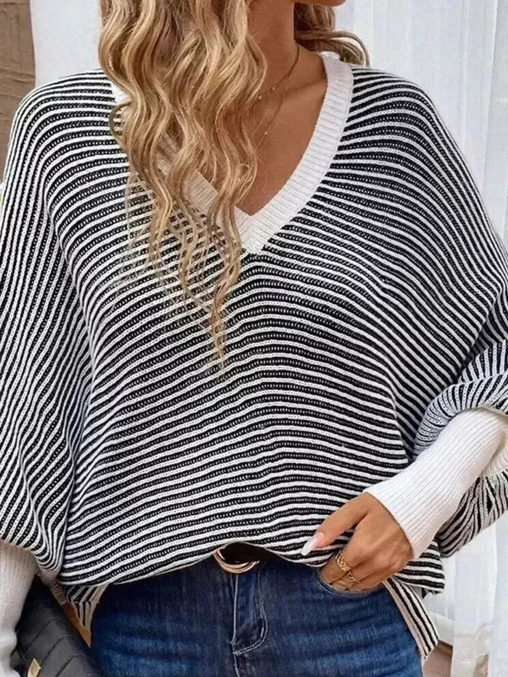 black v-neck sweater with hip-length and pullover