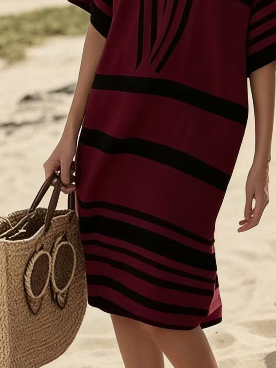 Burgundy and black striped half sleeve midi dress with a straw tote bag.
