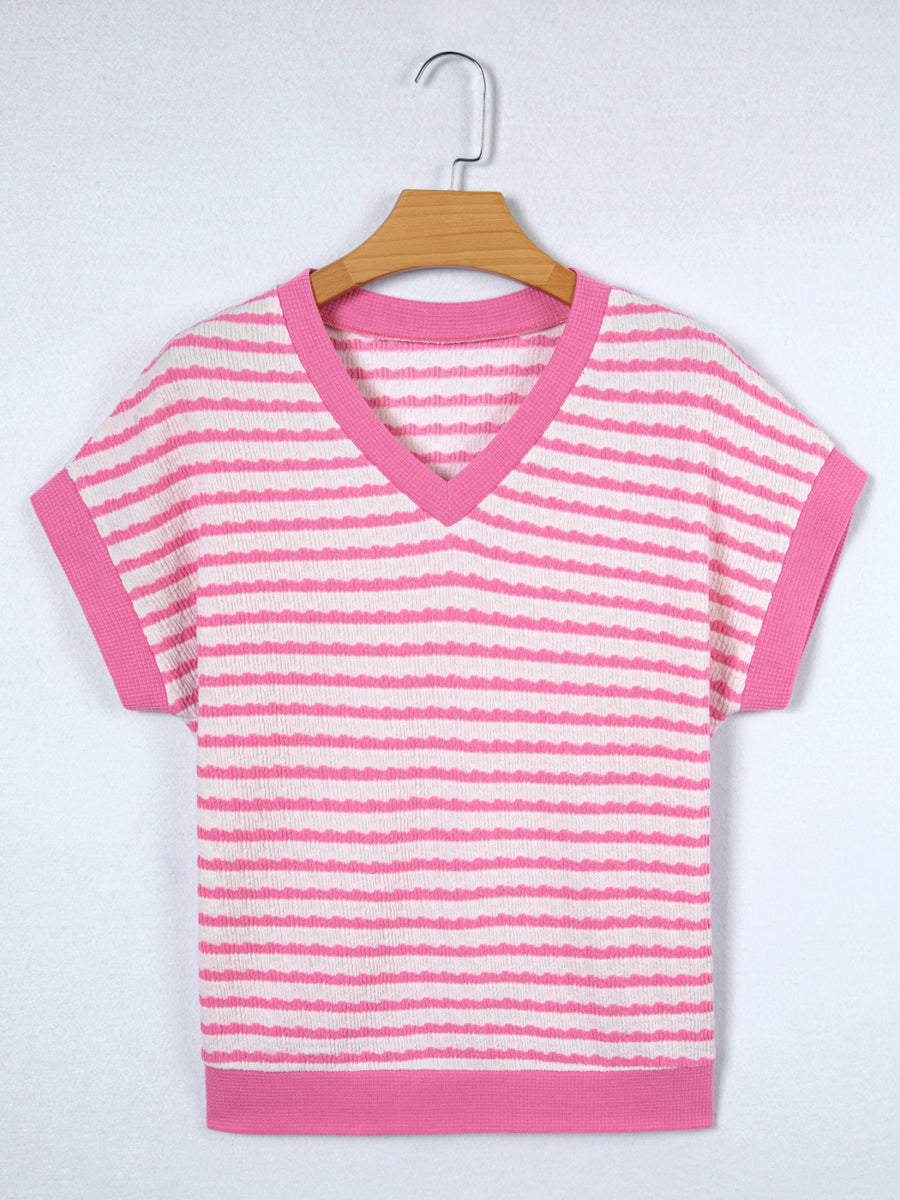 Textured pink and white striped V-neck t-shirt with short sleeves and pink trim.