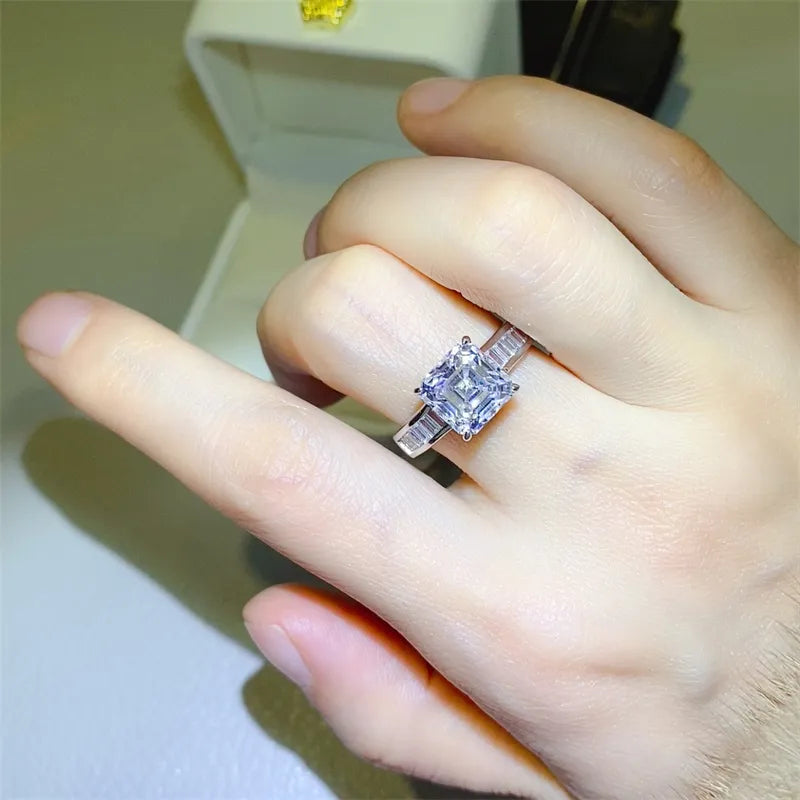 Silver ring with radiant emerald cut center stone and baguette side stones