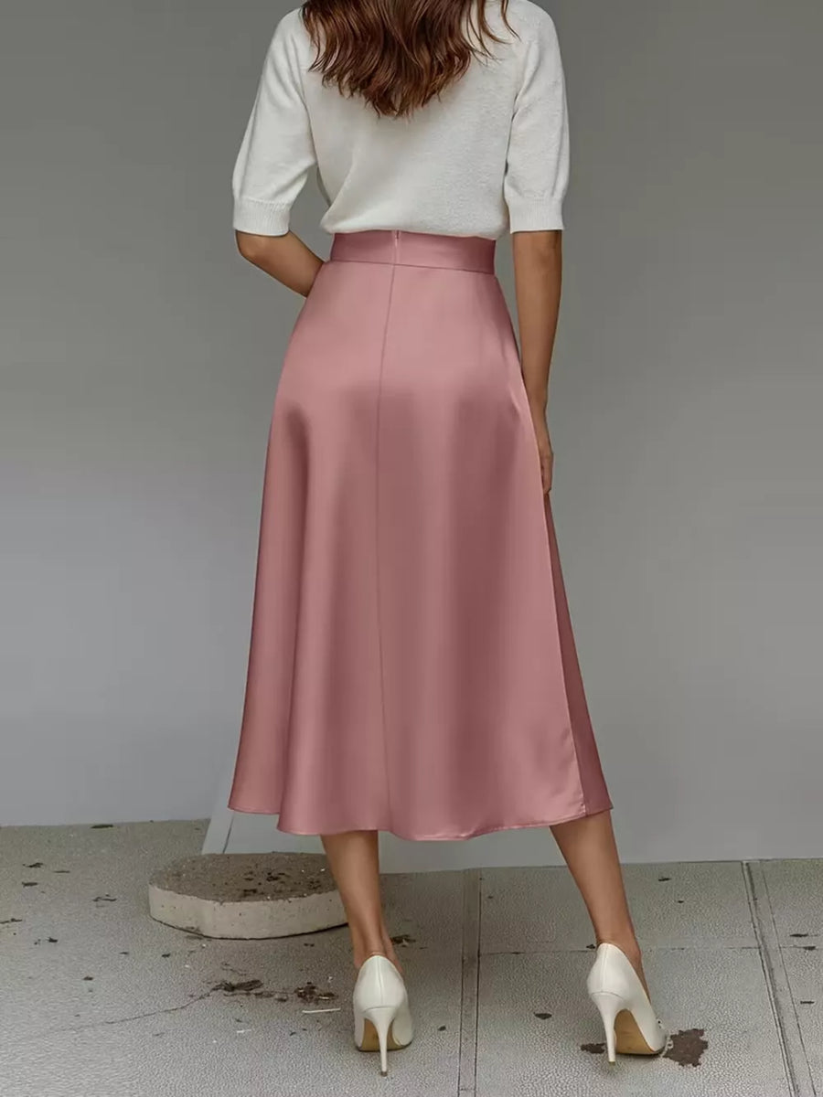 Pink satin A-line midi skirt with pockets, shown from the back.