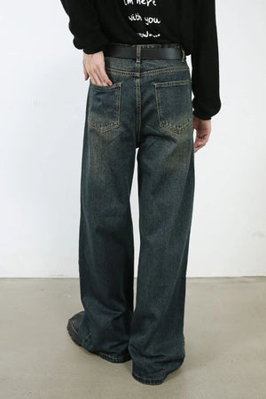 Faded denim wide-leg trousers in dark, with a relaxed fit and visible pocket details.