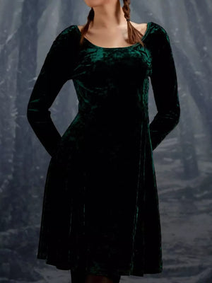 Emerald green velvet gown with round neck and long sleeves.