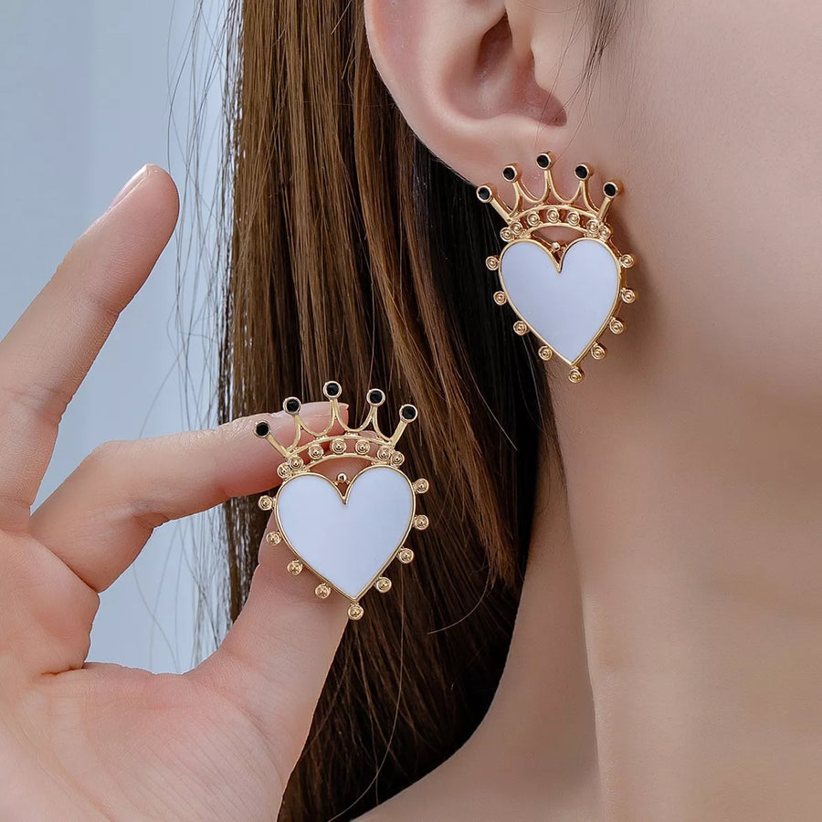 White heart crown stud earrings with gold trim and black accents.