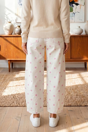 light pink wide-leg jeans featuring pocketed and polka dot
