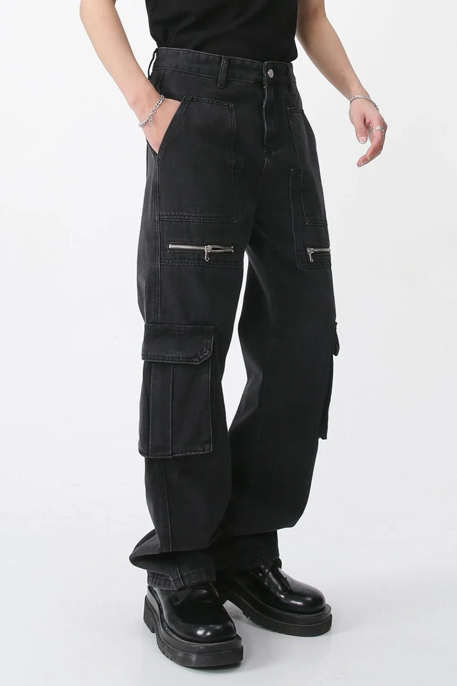 Dark denim wide-leg cargo pants with zip pockets and flap pockets.