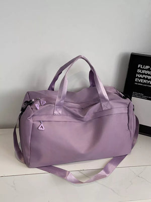 Duffel bag in lavender nylon with dual handles and adjustable shoulder strap, featuring multiple zippered pockets.