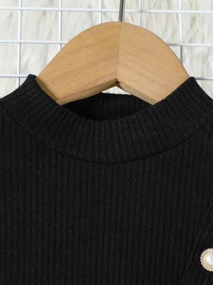 Black ribbed mock neck top with decorative pearl button detail