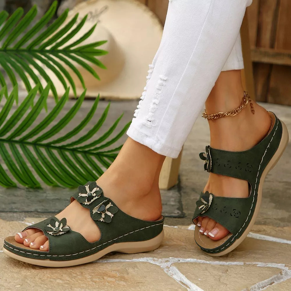 Army green sandals with floral appliqué detail and comfortable wedge sole.
