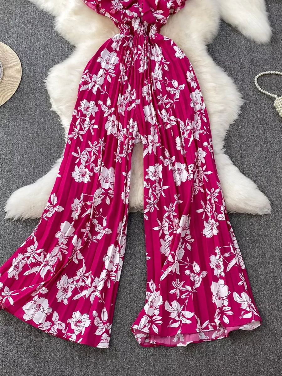 Rose Red floral pleated wide-leg romper with smocked waist and flowy legs.