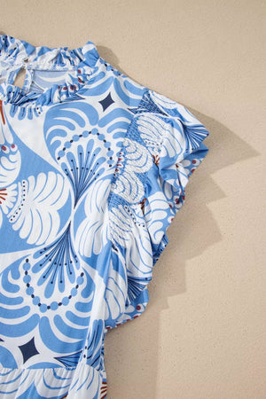 Blue and white botanical print ruffled dress with flutter sleeves and smocked details.