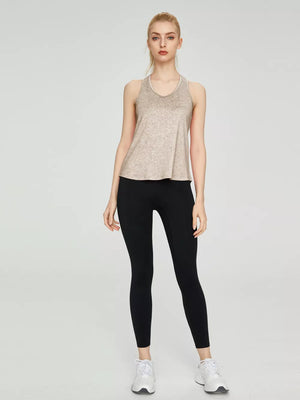 Lightweight heathered tank top in beige with a V-neck and racerback, paired with black leggings.
