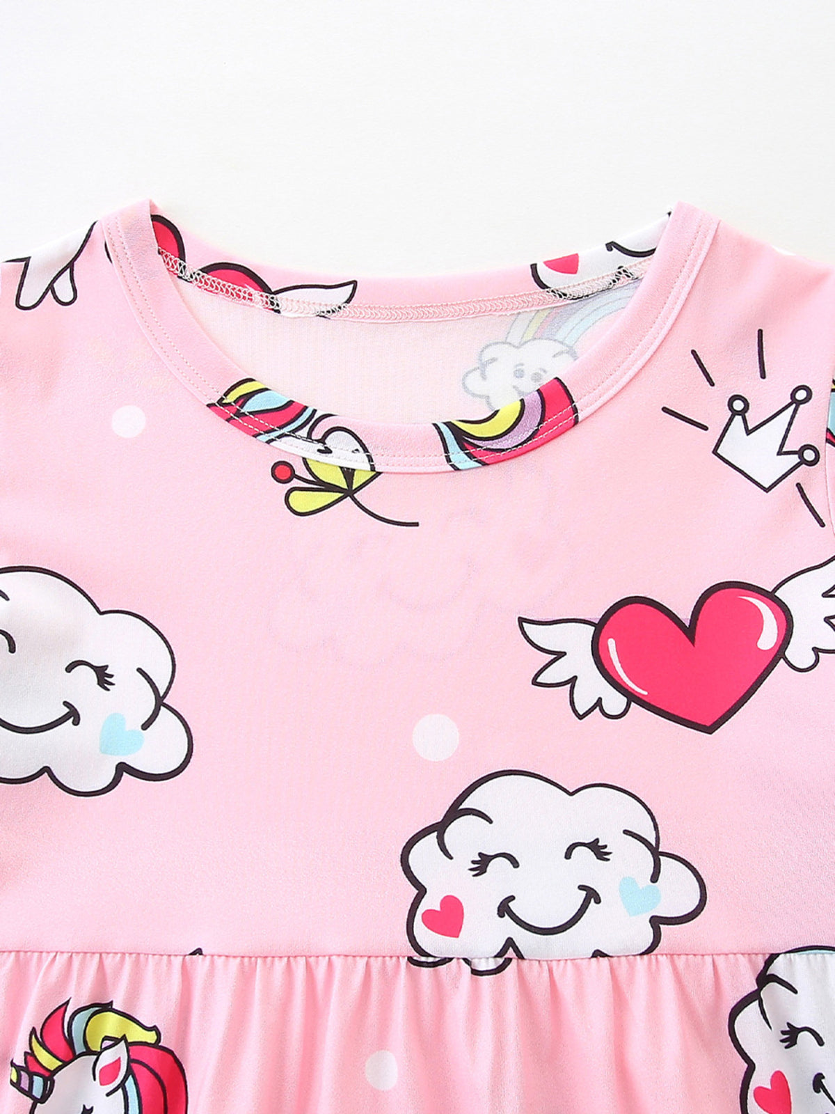 Pink toddler dress with unicorn, cloud, heart, and rainbow print.