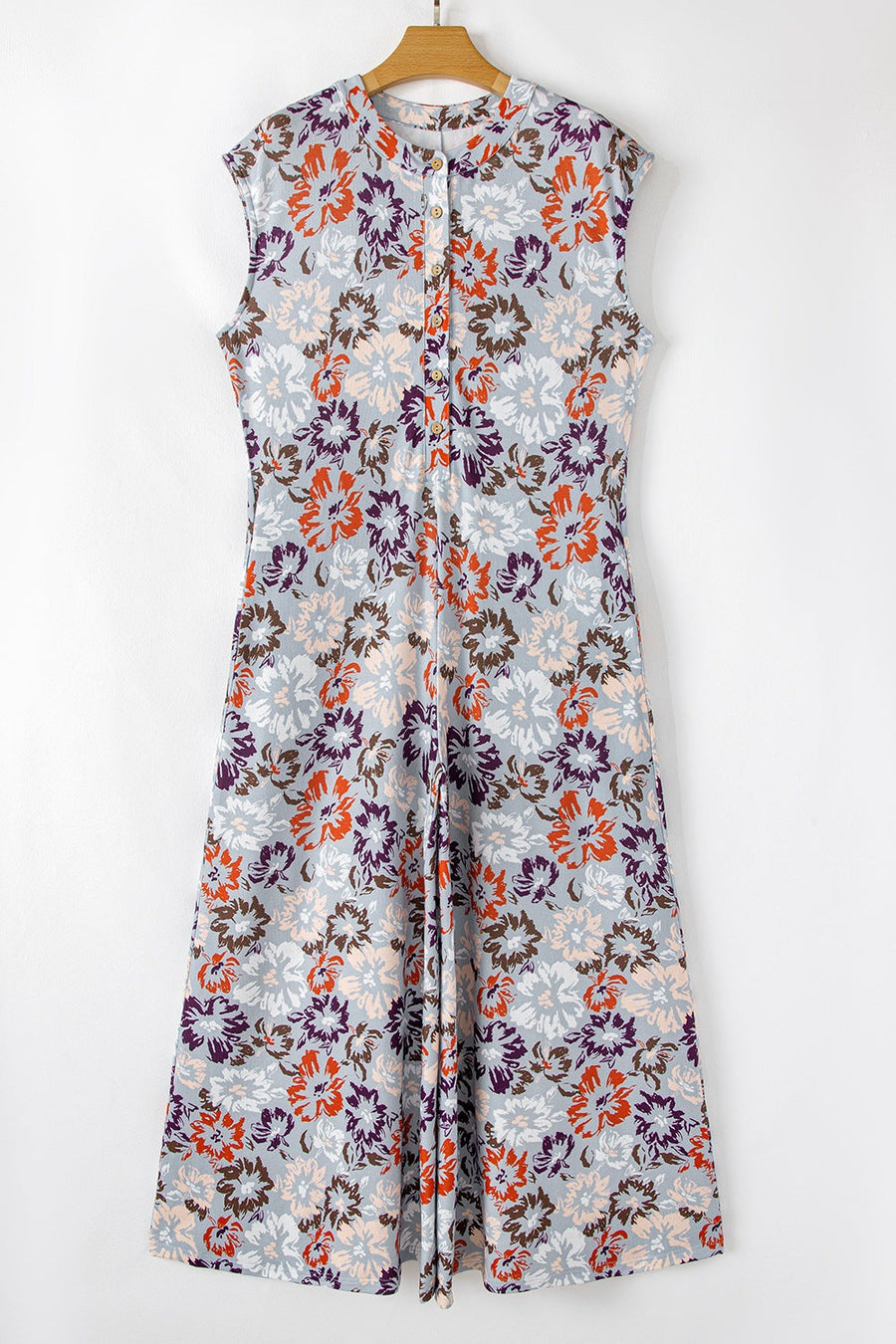 Floral cap-sleeve jumpsuit with a button-up front and wide legs.