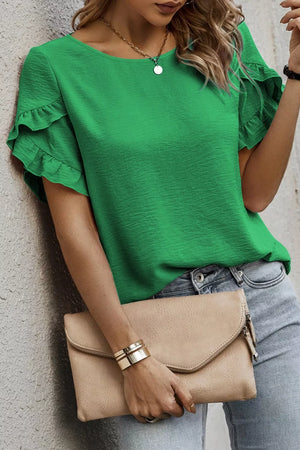 Green polyester short sleeve blouse with ruffle trim detail.