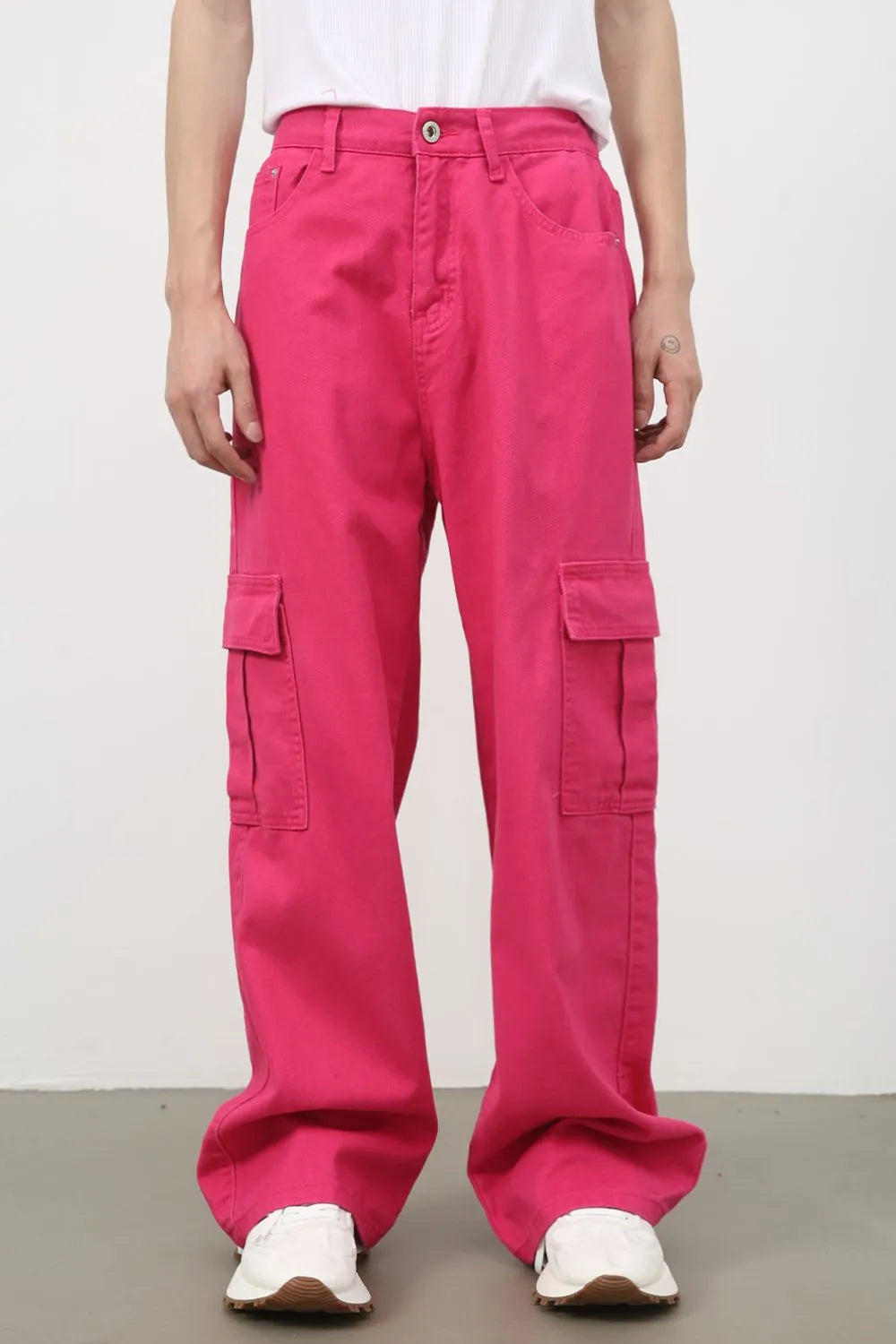 Electric pink baggy cargo pants with multiple pockets and a relaxed fit.