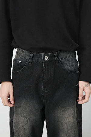 Dark wash wide leg denim jeans with faded details and distressed accents.