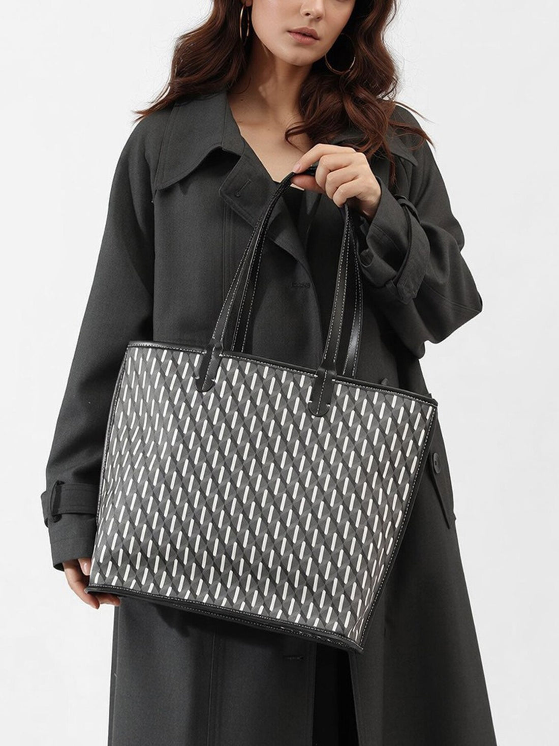black tote featuring top handles and geometric