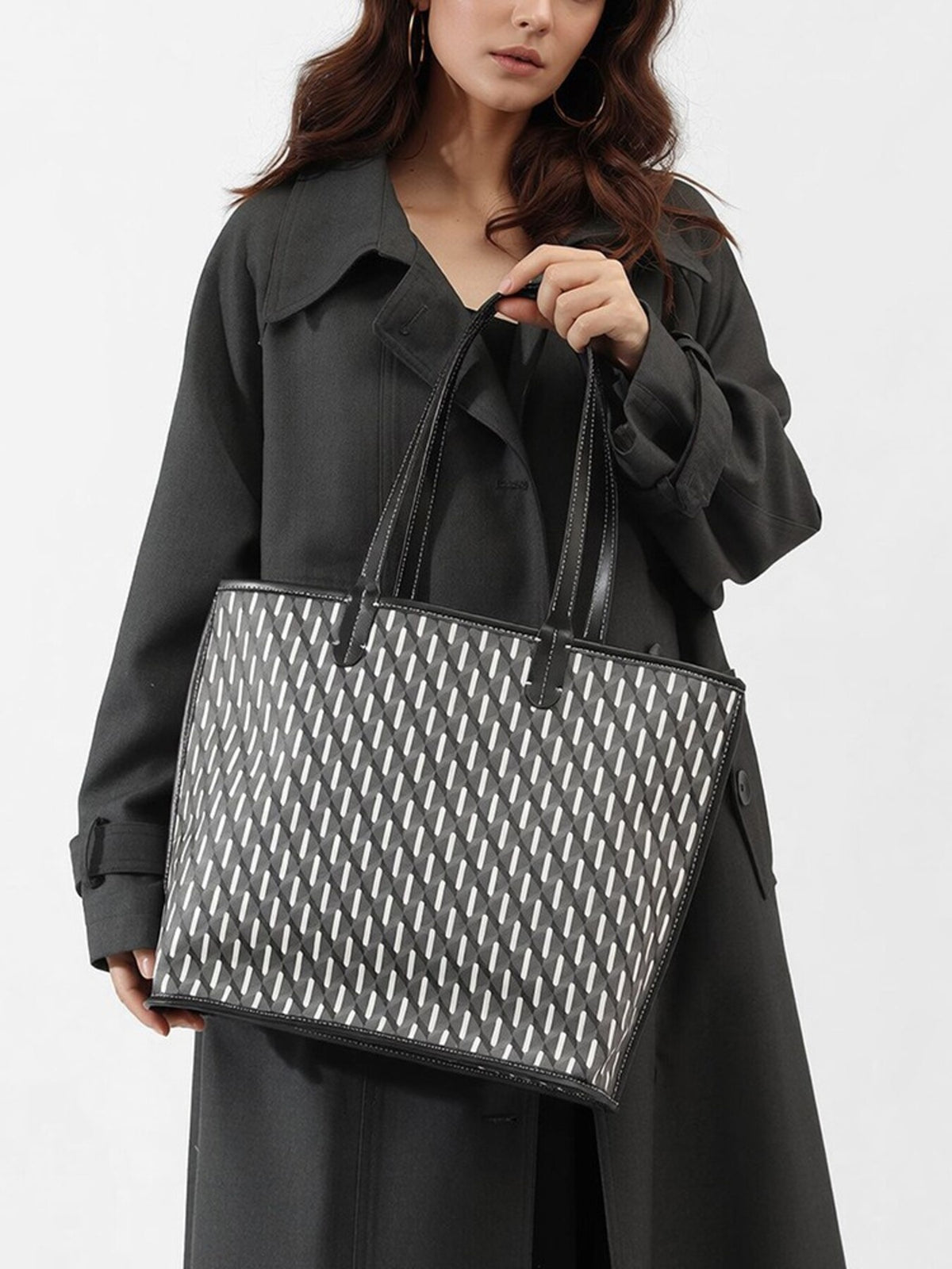 black tote featuring top handles and geometric