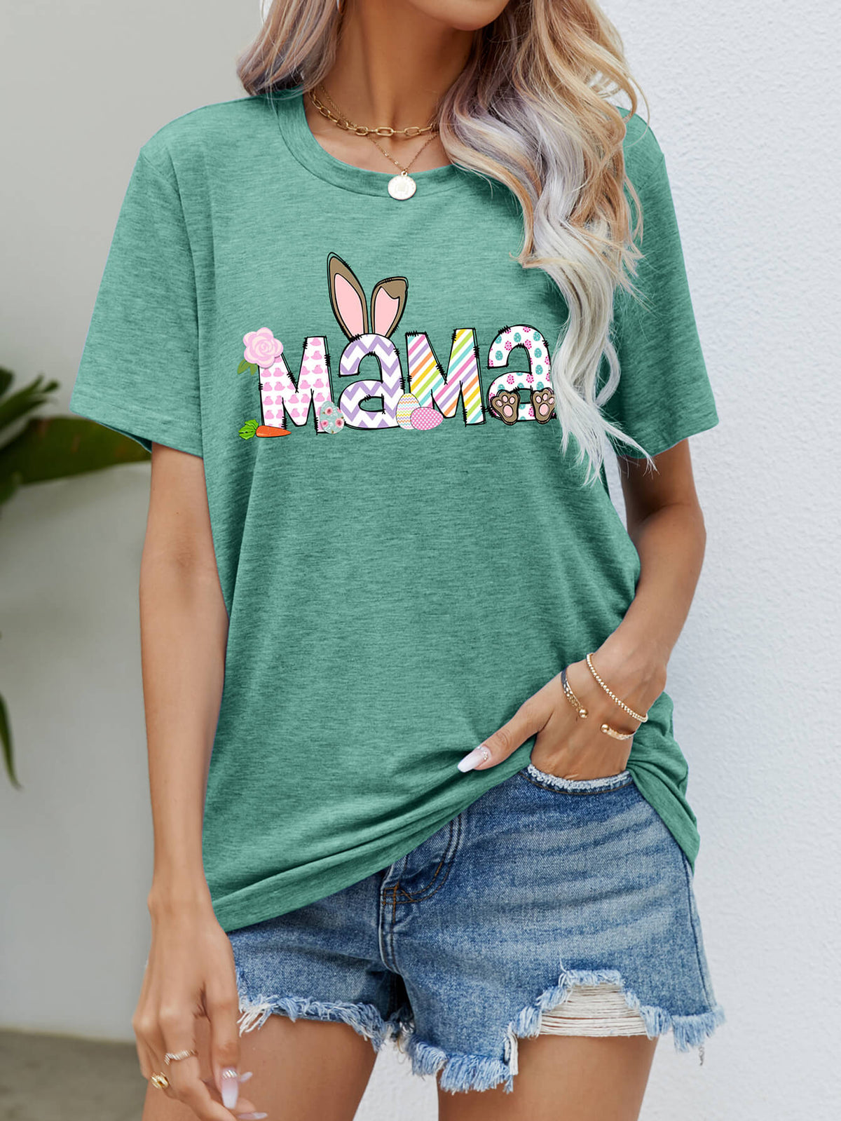 Gum Leaf green t-shirt with Easter Mama graphic featuring bunny ears and colorful patterns.