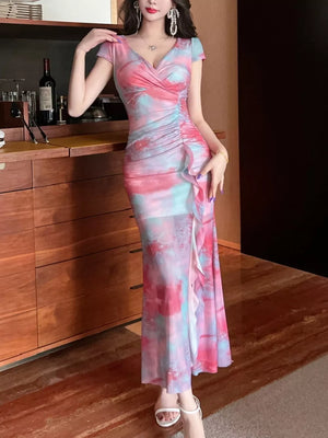Surplice ruffle maxi dress in pink and blue tie-dye with ruched side detail.