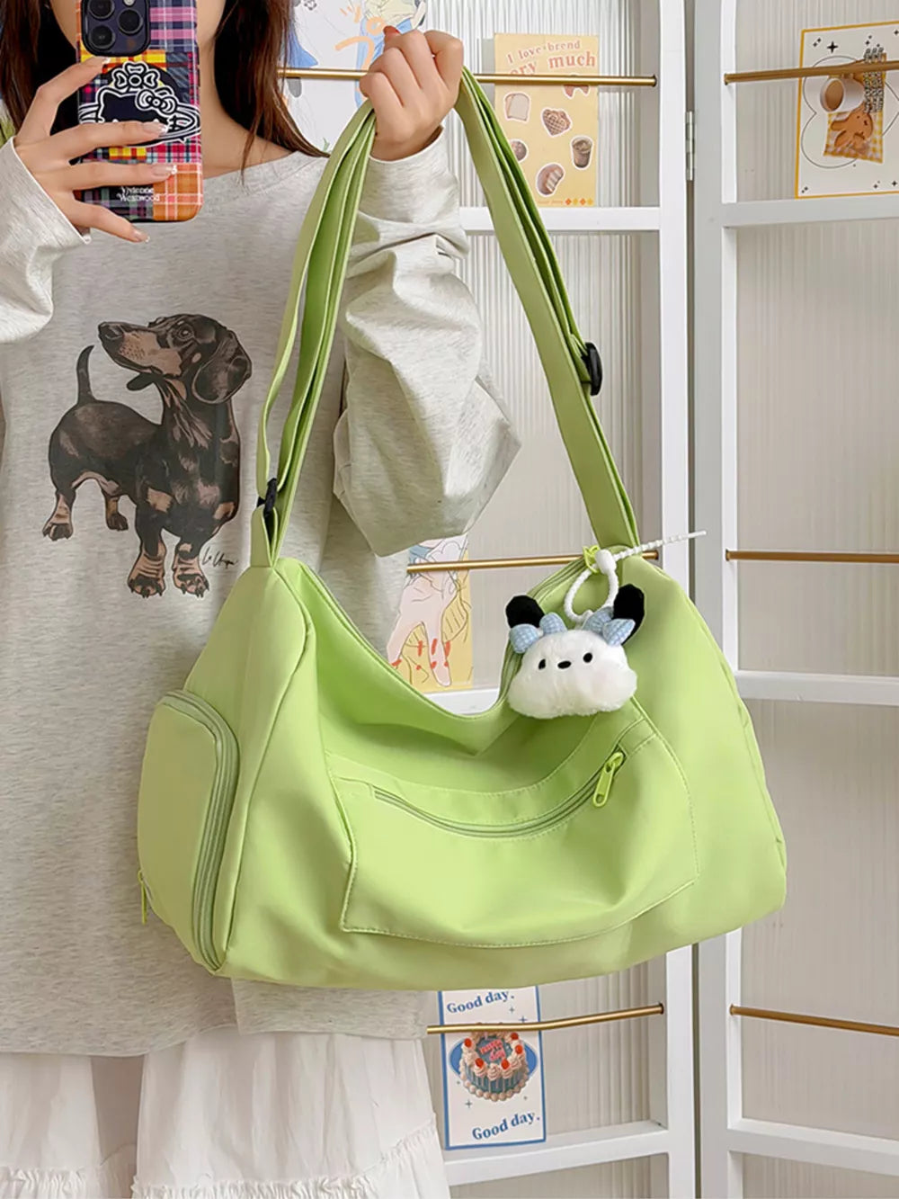 Vibrant light green travel bag with adjustable strap, multiple pockets, and cute charm.