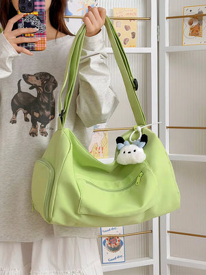 Vibrant light green travel bag with adjustable strap, multiple pockets, and cute charm.