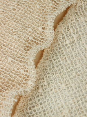 Openwork halter neck cover-up dress in cream textured knit with cutout details.