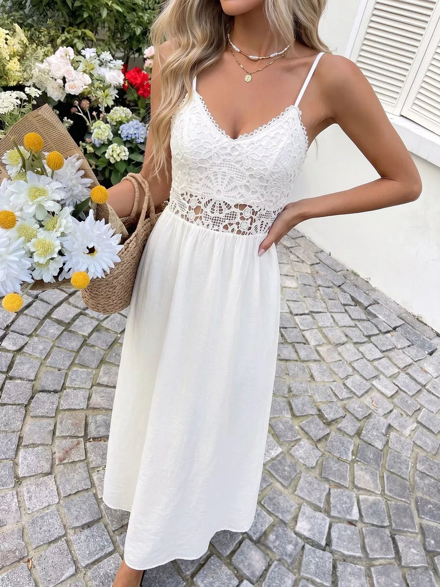 White lace V-neck maxi dress with cutout waist detail and spaghetti straps.