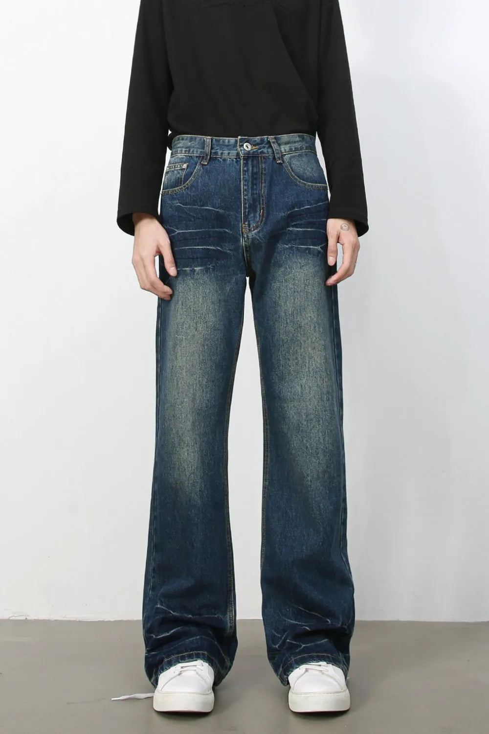 Faded wash flare jeans in dark blue denim with a relaxed fit and bootcut leg.