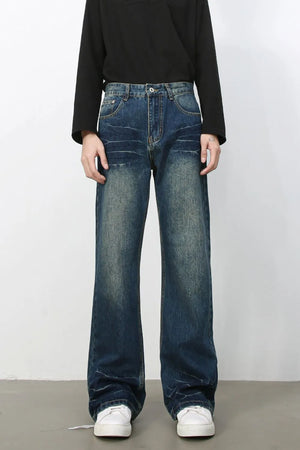 Faded wash flare jeans in dark blue denim with a relaxed fit and bootcut leg.