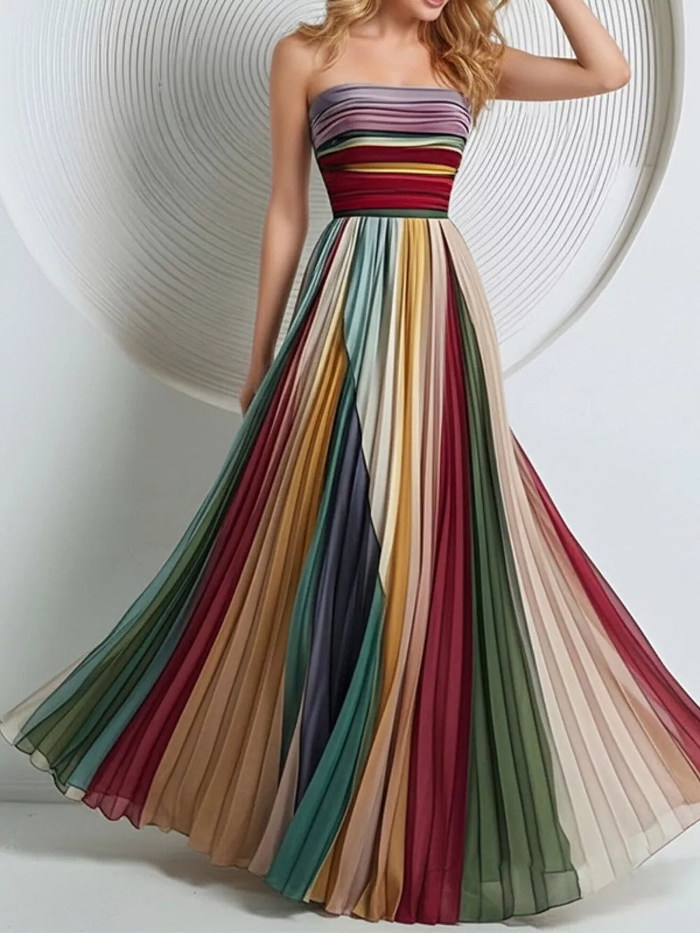 Vibrant striped pleated maxi dress with strapless bodice and flowing skirt.