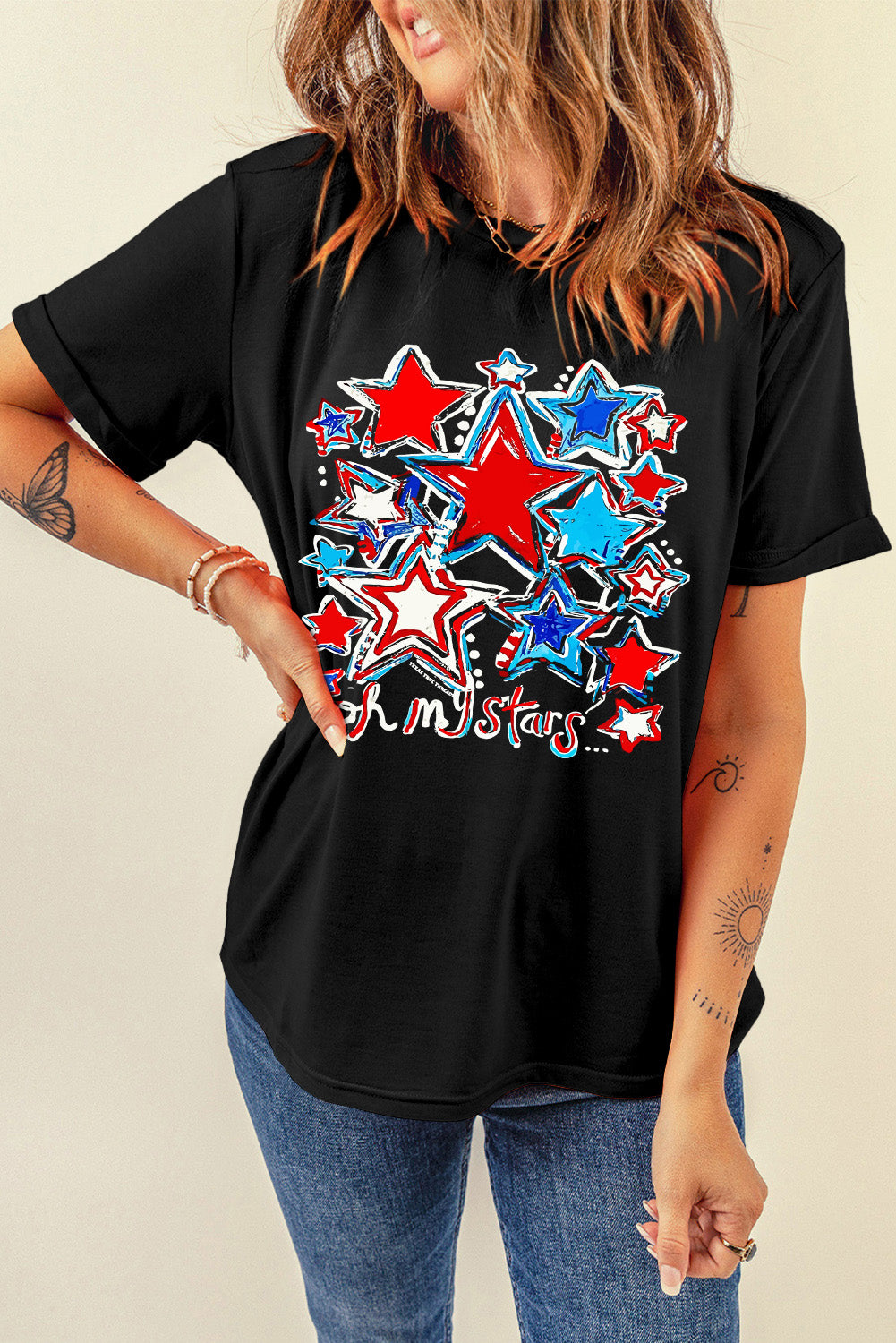 Black t-shirt with rolled sleeves featuring a red, white, and blue starburst graphic and text.