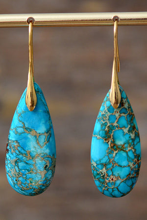 Teardrop jasper drop earrings in gold/blue with natural stone patterns.